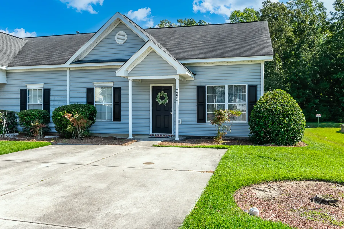 This image features the front entrance of the property, framed by charming landscaping and thoughtfully maintained greenery. The front door and windows add a welcoming touch, creating an inviting atmosphere that hints at evenings returning home after a night out.